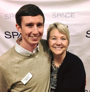 young man and his mother hug while celebrating SPACE's 26th anniversary
