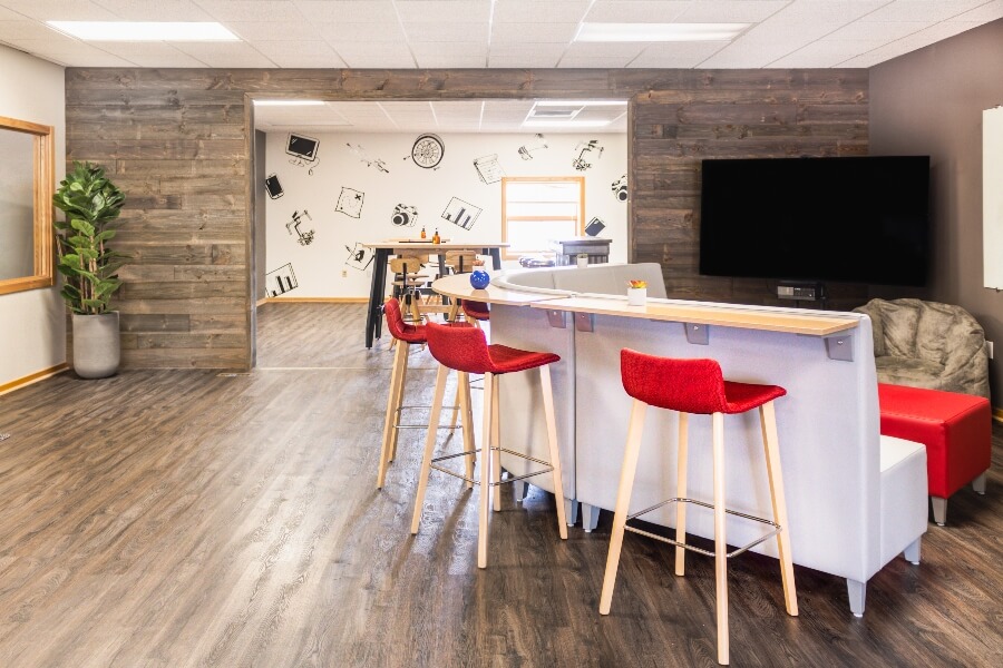 red stools at a workplace counter in large, wood paneled office