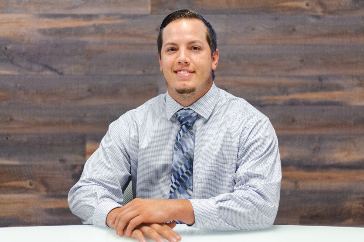 white craftsman sits at office desk