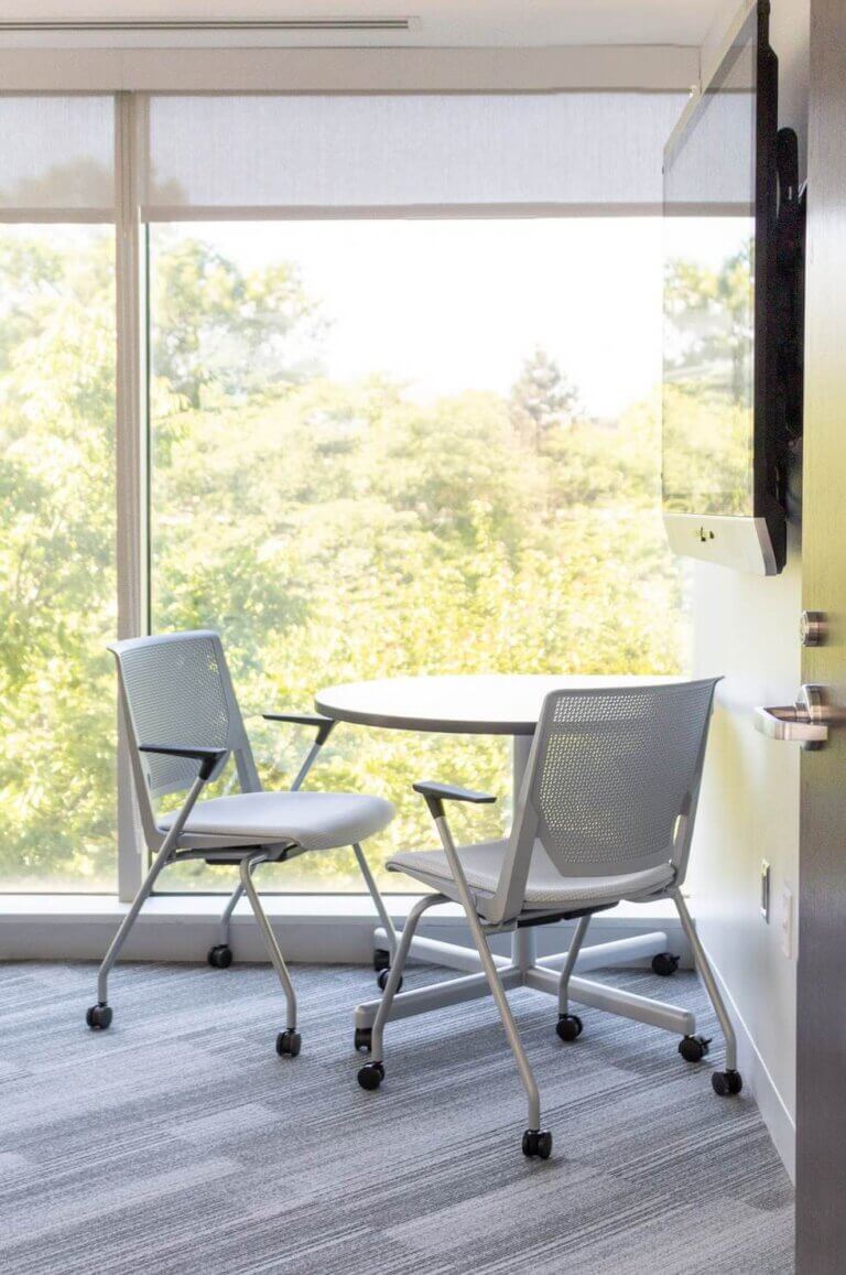 two white office chairs near bright window